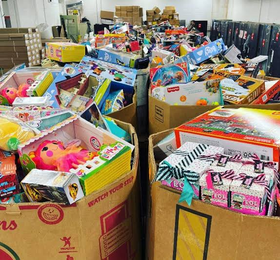 Target and Walmart Christmas liquidation pallets stacked in a wholesale warehouse ready for resale.