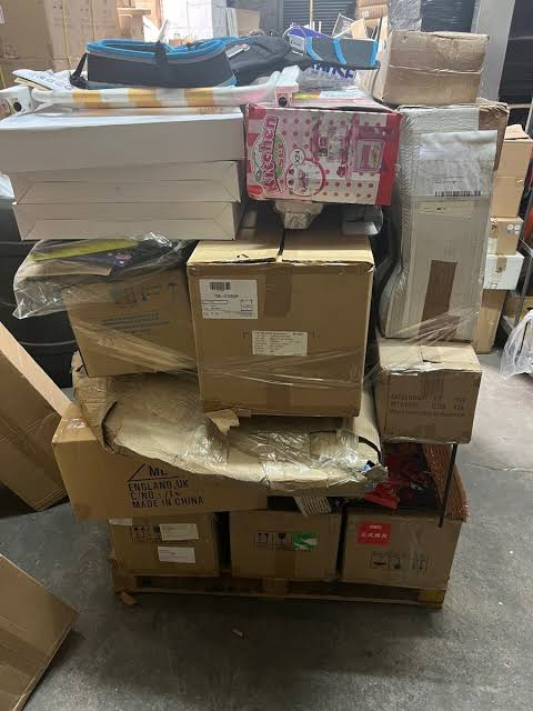 Shrink wrapped post Christmas liquidation sales pallets inside a wholesale warehouse